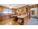 Eat-in kitchen with wood-paneled walls features a breakfast bar and round dining table at 3017 Lynwood Dr, Lancaster, SC 29720