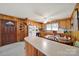 Eat-in kitchen boasts wood paneled walls and includes a breakfast bar and round dining table at 3017 Lynwood Dr, Lancaster, SC 29720
