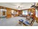 Living room with wood paneling, a rocking chair, and access to other rooms in the home at 3017 Lynwood Dr, Lancaster, SC 29720