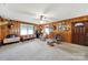 Cozy living room with wood paneling, carpet, rocking chairs, and deer mounts at 3017 Lynwood Dr, Lancaster, SC 29720