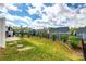 Fenced backyard featuring a lush lawn, patio, and manicured garden beds at 3021 Patchwork Ct, Fort Mill, SC 29708