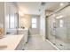 Bright bathroom with a sleek glass shower, dual vanities, and modern tile flooring at 3021 Patchwork Ct, Fort Mill, SC 29708