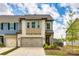 Charming townhouse showcasing a two-car garage and well-manicured front yard at 3021 Patchwork Ct, Fort Mill, SC 29708