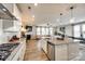 Open-concept kitchen with granite counters and modern stainless steel appliances overlooking the living area at 3021 Patchwork Ct, Fort Mill, SC 29708