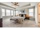 Inviting main bedroom boasts a tray ceiling, neutral tones, and a cozy seating bench at 3021 Patchwork Ct, Fort Mill, SC 29708
