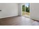 Bright room featuring a sliding glass door that opens to a back porch, with wood-look flooring at 3034 Trailblazer St, Charlotte, NC 28215