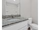 Charming bathroom featuring a granite countertop, large mirror, and a shower-tub combination at 3034 Trailblazer St, Charlotte, NC 28215