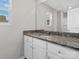 Bright bathroom features a vanity with granite countertop, white cabinets, and a large mirror, offering style and functionality at 3034 Trailblazer St, Charlotte, NC 28215