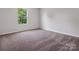 Carpeted bedroom with a window offering natural light, providing a serene living space at 3034 Trailblazer St, Charlotte, NC 28215