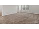 Carpeted bedroom with natural light entering through a large window creating a warm and inviting atmosphere at 3034 Trailblazer St, Charlotte, NC 28215