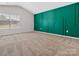 Large bedroom with decorative green accent wall and carpeted flooring, natural light from window at 3034 Trailblazer St, Charlotte, NC 28215