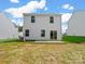 Rear exterior of the home featuring a small patio and a grassy backyard at 3034 Trailblazer St, Charlotte, NC 28215