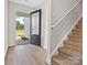 Bright foyer featuring a staircase, wood-look floors, and a front door with glass inserts at 3034 Trailblazer St, Charlotte, NC 28215