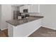 Modern kitchen island with granite countertops, stainless steel sink, and a stylish breakfast bar area at 3034 Trailblazer St, Charlotte, NC 28215