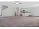 Bright and open living room with neutral tones, flowing into the kitchen and dining area at 3034 Trailblazer St, Charlotte, NC 28215