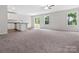 Spacious living room with carpet, large windows, and an open floor plan to the kitchen at 3034 Trailblazer St, Charlotte, NC 28215