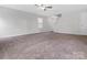 Large, carpeted living room with ample natural light and staircase access, great for Gathering gatherings at 3034 Trailblazer St, Charlotte, NC 28215
