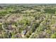 A serene, aerial view of a neighborhood showcasing homes surrounded by dense, mature trees at 310 Frontier Cir, Indian Trail, NC 28079