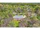 Aerial view of a large home with a deck, surrounded by trees, offering privacy and scenic beauty at 310 Frontier Cir, Indian Trail, NC 28079