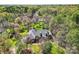 A lovely home with dormer windows is surrounded by lush greenery and mature trees in this aerial view at 310 Frontier Cir, Indian Trail, NC 28079