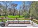 Scenic back deck with comfortable seating and a view of the expansive, tree-lined backyard at 310 Frontier Cir, Indian Trail, NC 28079