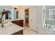 Bright bathroom with double vanity, glass-enclosed shower, and separate soaking tub at 310 Frontier Cir, Indian Trail, NC 28079