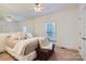 Comfortable bedroom featuring neutral walls, carpet flooring, and a window overlooking the backyard at 310 Frontier Cir, Indian Trail, NC 28079