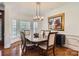 Elegant dining room with hardwood floors, chandelier, and wainscoting at 310 Frontier Cir, Indian Trail, NC 28079