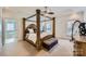 Main bedroom with four poster bed, neutral carpet, and tray ceiling at 310 Frontier Cir, Indian Trail, NC 28079