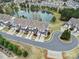 Aerial view features townhomes, a pond with a fountain, lush landscaping, and a circular driveway at 44455 Oriole Dr # 100, Indian Land, SC 29707