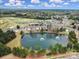 An aerial view showcases townhomes surrounding a pond with fountains and nearby golf course at 44455 Oriole Dr # 100, Indian Land, SC 29707