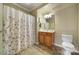 Traditional bathroom featuring a shower-tub combination with a floral curtain and a vanity at 44455 Oriole Dr # 100, Indian Land, SC 29707