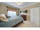 Well-lit bedroom with classic dresser, bright window, and neutral decor at 44455 Oriole Dr # 100, Indian Land, SC 29707