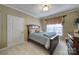 Cozy bedroom featuring a comfortable bed, classic dresser, and decorative window treatment at 44455 Oriole Dr # 100, Indian Land, SC 29707