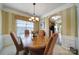Sophisticated dining room with large windows, striped wallpaper, and a charming chandelier at 44455 Oriole Dr # 100, Indian Land, SC 29707