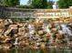Stone waterfall feature at the entrance to Sun City Carolina Lakes by Del Webb community at 44455 Oriole Dr # 100, Indian Land, SC 29707