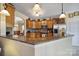 The kitchen features an island with granite countertops, stainless steel appliances, and warm cabinetry at 44455 Oriole Dr # 100, Indian Land, SC 29707