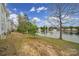 Picturesque lake view featuring a fountain and surrounding trees and vegetation at 44455 Oriole Dr # 100, Indian Land, SC 29707