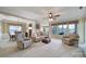 Comfortable living room featuring neutral tones, a ceiling fan, and large windows at 44455 Oriole Dr # 100, Indian Land, SC 29707