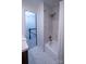 Clean bathroom with tub and shower, with white tiles and modern fixtures at 4609 Hedgemore Dr # I, Charlotte, NC 28209