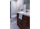 Modern bathroom featuring a dark wood vanity, white countertop, and nice lighting at 4609 Hedgemore Dr # I, Charlotte, NC 28209