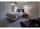 This bedroom boasts carpet, a ceiling fan, a closet and natural light from the windows at 4609 Hedgemore Dr # I, Charlotte, NC 28209