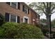 Brick townhome featuring dark shutters, tasteful landscaping, and classic architectural elements, offering a blend of charm and curb appeal at 4609 Hedgemore Dr # I, Charlotte, NC 28209