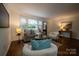 Cozy living room with hardwood floors, large window, comfortable seating, and tasteful decor, perfect for relaxation and entertaining guests at 4609 Hedgemore Dr # I, Charlotte, NC 28209