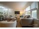 Bright living room features hardwood floors, large windows, and modern decor, creating a comfortable and inviting space at 4609 Hedgemore Dr # I, Charlotte, NC 28209