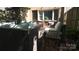 This outdoor brick patio features comfortable seating and a privacy fence at 4609 Hedgemore Dr # I, Charlotte, NC 28209