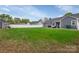 Expansive backyard with a well-maintained lawn, fence, and a gray house at 4808 Truscott Rd, Charlotte, NC 28226