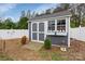 Backyard shed with gray walls, white trim, a window and wooden platform at 4808 Truscott Rd, Charlotte, NC 28226