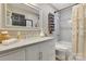 Bathroom featuring a marble vanity, a large mirror, a white tiled shower/tub, and neutral colors at 4808 Truscott Rd, Charlotte, NC 28226