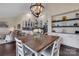 Bright dining room featuring a chandelier and view of a modern kitchen with stainless steel appliances at 4808 Truscott Rd, Charlotte, NC 28226
